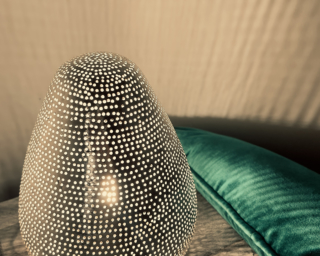 Hand punched Egyptian table lamp in dots with couch